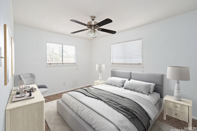 bedroom featuring ceiling fan and light colored carpet