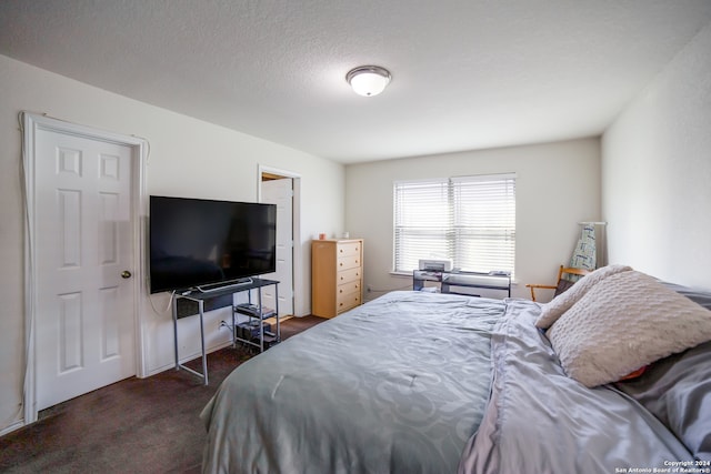 carpeted bedroom featuring a textured ceiling