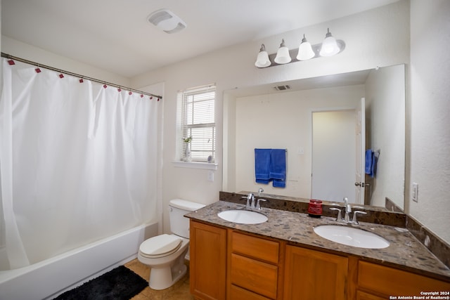 full bathroom featuring vanity, shower / bath combo with shower curtain, and toilet