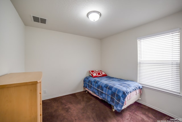 carpeted bedroom featuring a textured ceiling