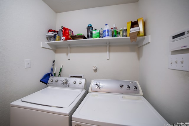 clothes washing area with washer and dryer