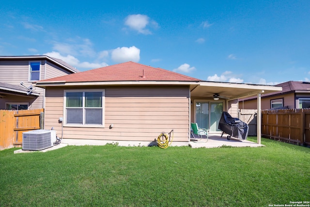 back of house featuring ceiling fan, a patio, central AC unit, and a lawn