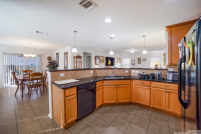 kitchen featuring sink, kitchen peninsula, pendant lighting, fridge, and dishwasher