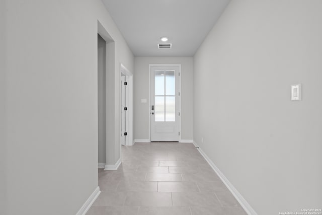 doorway with light tile patterned floors