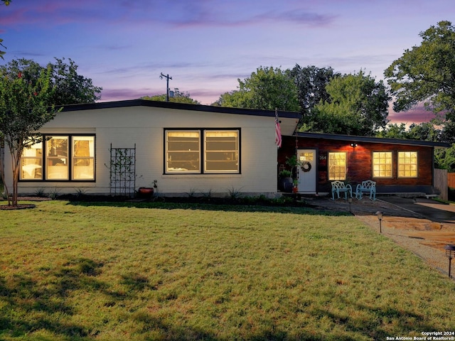 view of front facade featuring a yard and a patio