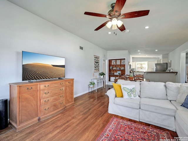 living room with ceiling fan and hardwood / wood-style floors