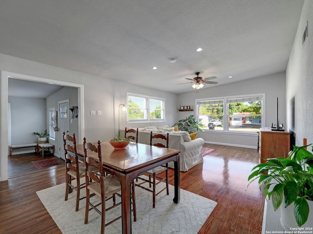 dining area with lofted ceiling, ceiling fan, dark hardwood / wood-style floors, and a healthy amount of sunlight