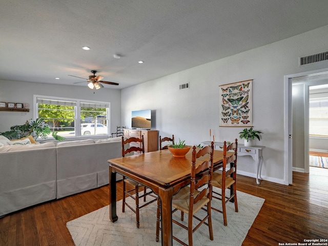 dining area with ceiling fan, a textured ceiling, and dark hardwood / wood-style floors