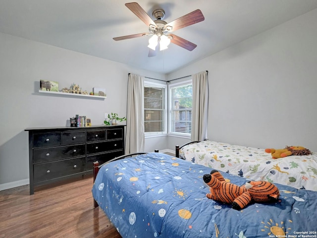 bedroom with ceiling fan and dark hardwood / wood-style floors