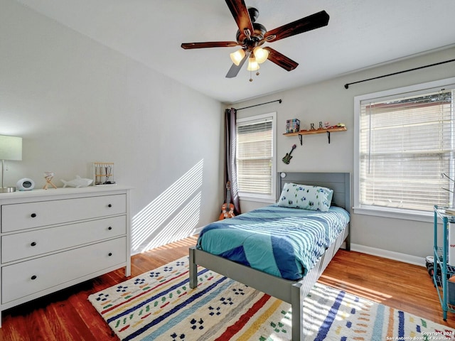 bedroom with ceiling fan and hardwood / wood-style floors