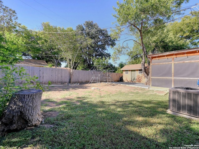 view of yard with a storage shed and central AC