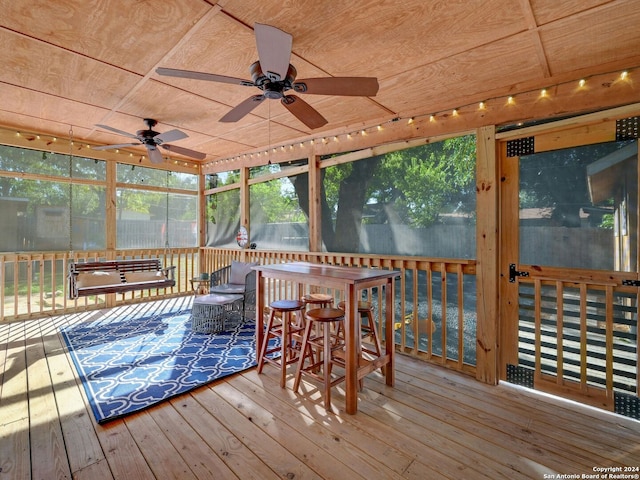 sunroom / solarium featuring ceiling fan and wooden ceiling