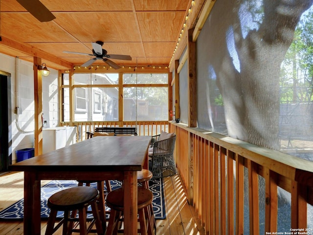 sunroom featuring wooden ceiling and ceiling fan