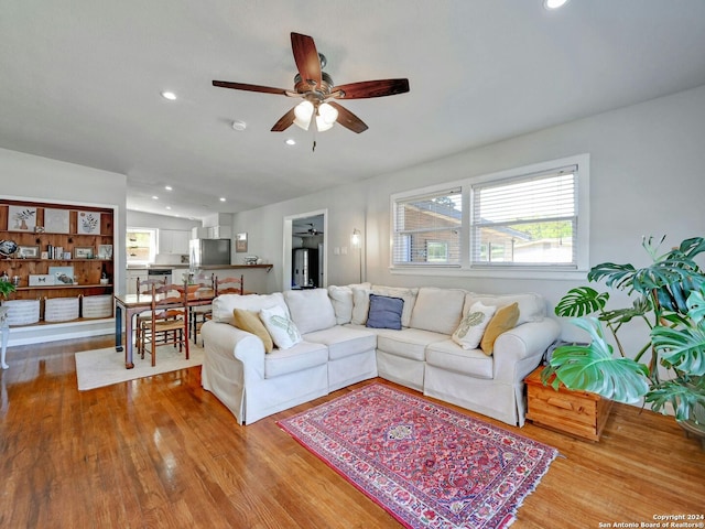 living room featuring light hardwood / wood-style floors and ceiling fan