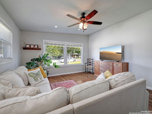 living room with wood-type flooring and ceiling fan