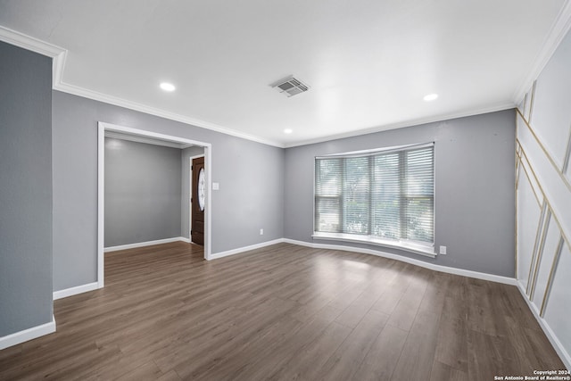 empty room featuring ornamental molding and dark hardwood / wood-style floors