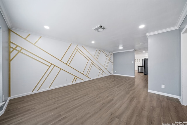 unfurnished room with crown molding and wood-type flooring