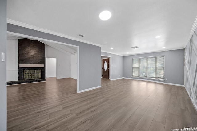 unfurnished living room featuring ornamental molding, a fireplace, and hardwood / wood-style floors