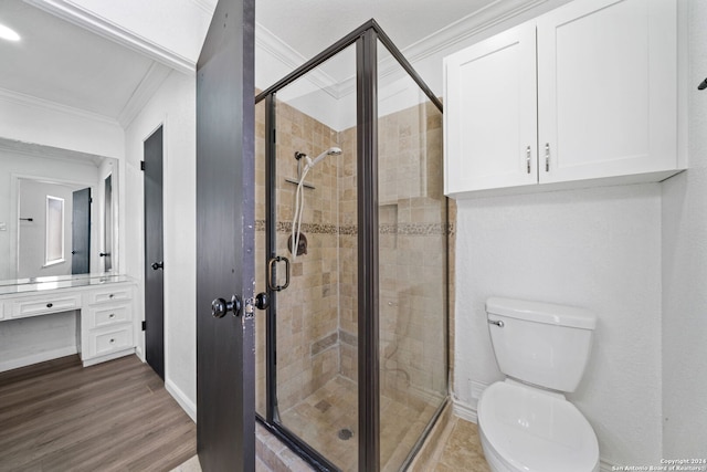 bathroom with toilet, an enclosed shower, ornamental molding, vanity, and hardwood / wood-style flooring