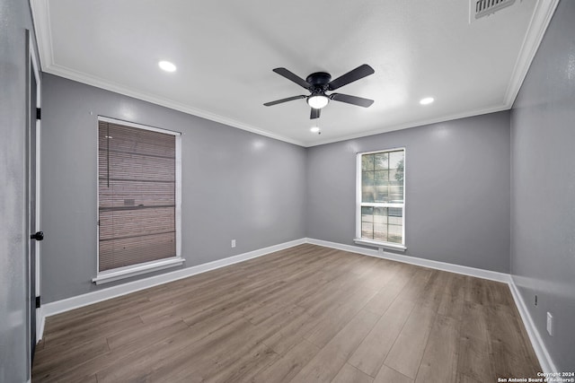 unfurnished room with hardwood / wood-style flooring, crown molding, and ceiling fan