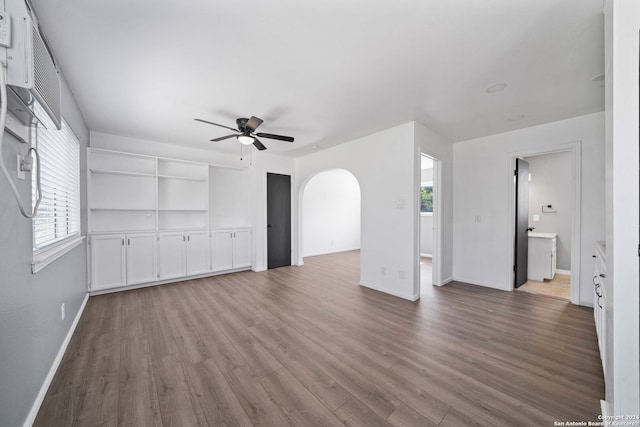 unfurnished living room featuring light wood-type flooring and ceiling fan