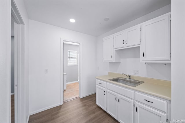 kitchen with white cabinetry, sink, and dark hardwood / wood-style flooring