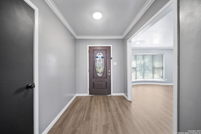 foyer featuring crown molding and light wood-type flooring