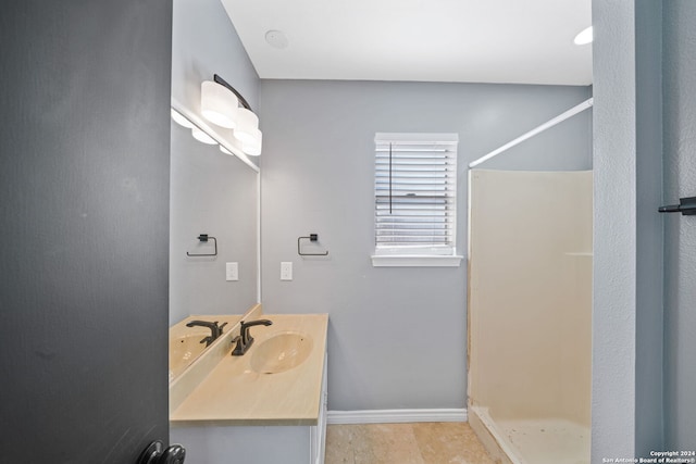 bathroom with vanity and a shower