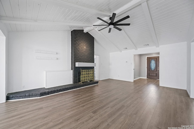 unfurnished living room with hardwood / wood-style flooring, ceiling fan, a brick fireplace, and beamed ceiling