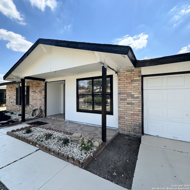 view of front of house featuring brick siding and a garage