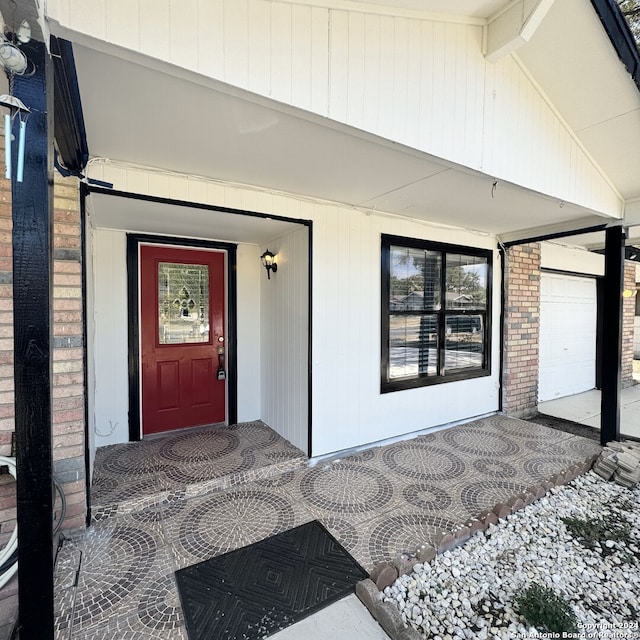 view of exterior entry featuring brick siding