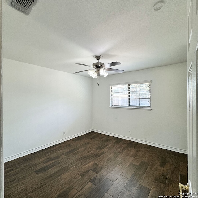 unfurnished room with dark hardwood / wood-style floors and ceiling fan