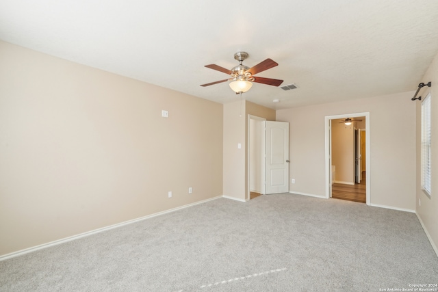 unfurnished bedroom featuring light colored carpet and ceiling fan