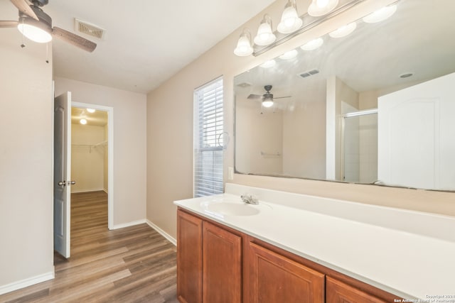 bathroom featuring an enclosed shower, vanity, and hardwood / wood-style flooring