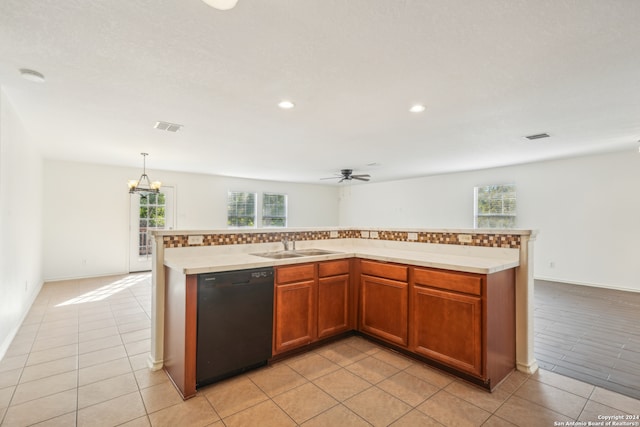 kitchen featuring a center island with sink, sink, ceiling fan with notable chandelier, pendant lighting, and dishwasher