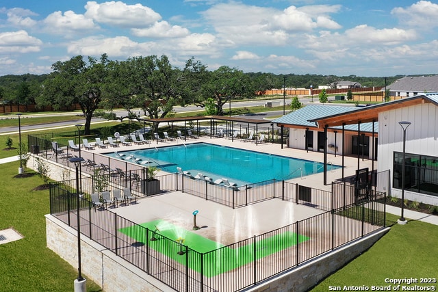 view of swimming pool featuring a patio and a lawn