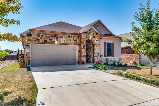 view of front of home featuring a front yard and a garage