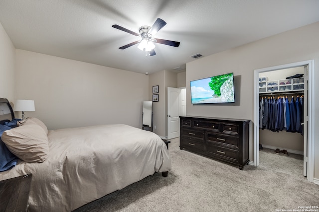 carpeted bedroom featuring ceiling fan, a textured ceiling, a closet, and a spacious closet