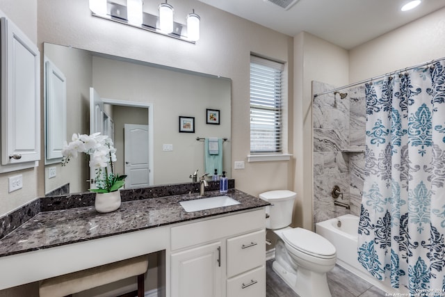 full bathroom featuring tile patterned flooring, toilet, shower / bath combo with shower curtain, and vanity