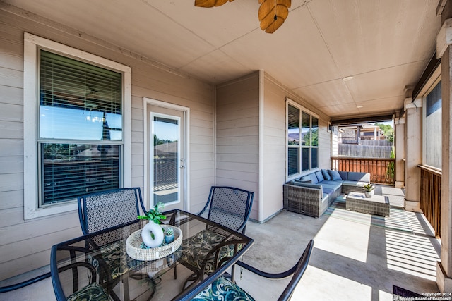 view of patio with an outdoor living space and ceiling fan