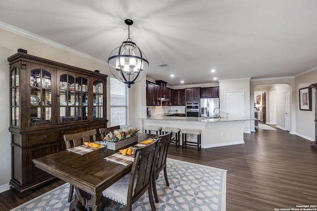 dining area featuring ornamental molding, a notable chandelier, and dark hardwood / wood-style floors