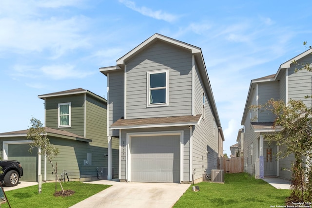 view of front property featuring a front lawn, central air condition unit, and a garage