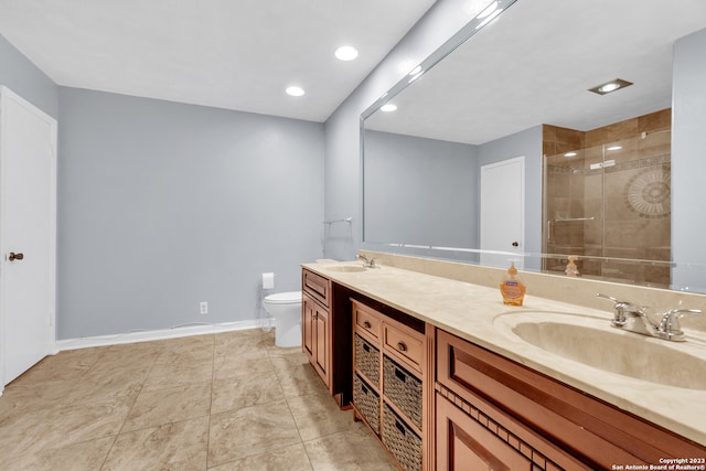 bathroom featuring a tile shower, vanity, tile patterned flooring, and toilet