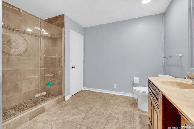 bathroom with vanity, toilet, and a shower with shower door