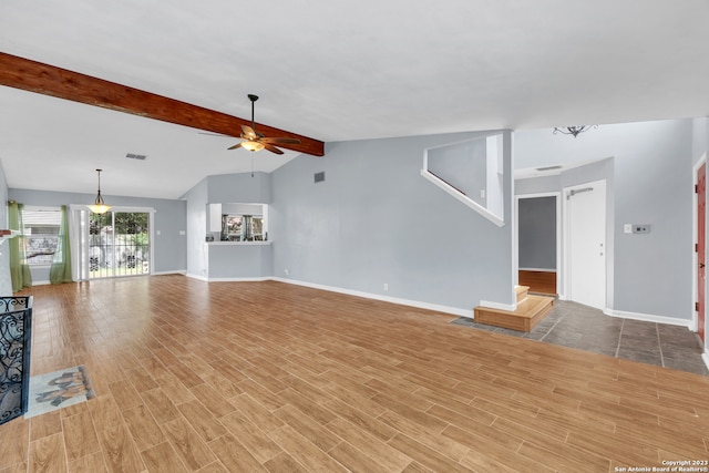 unfurnished living room with ceiling fan, vaulted ceiling with beams, and hardwood / wood-style floors