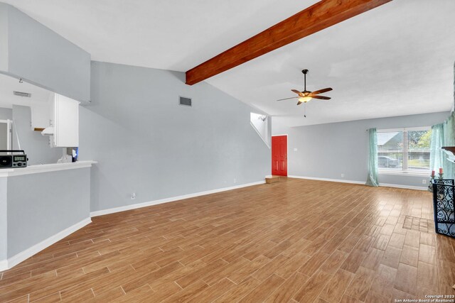 6906 Country Elm, San Antonio, TX 78240 - unfurnished living room featuring a ceiling fan, visible vents, baseboards, lofted ceiling with beams, and light wood-style flooring