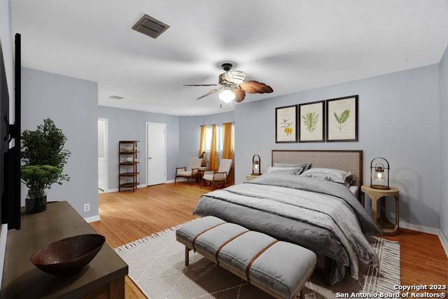 bedroom with ceiling fan and wood-type flooring