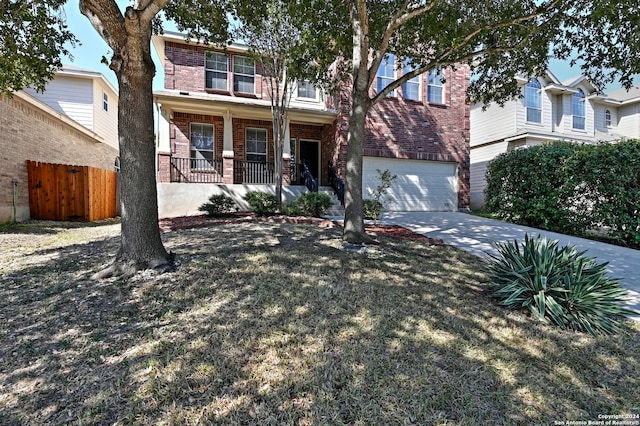 view of front of home featuring a front lawn, a porch, and a garage