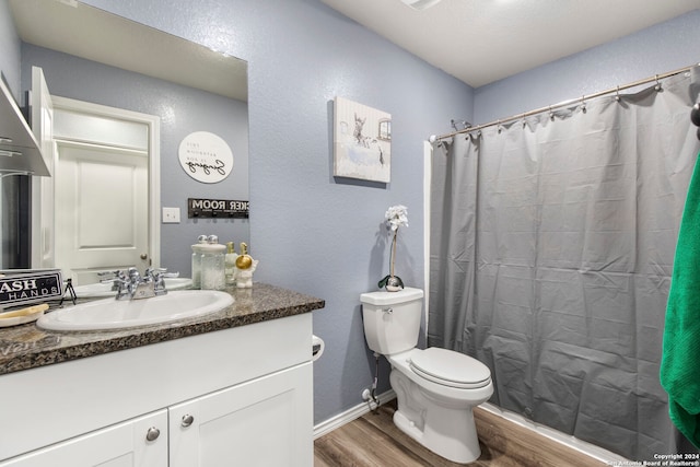 bathroom with vanity, hardwood / wood-style floors, toilet, and a shower with shower curtain