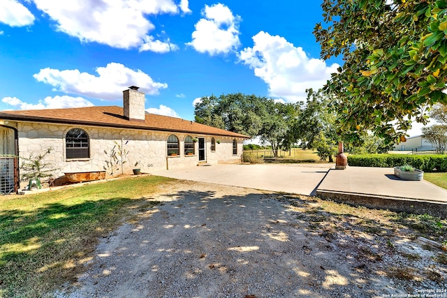 back of property with a patio